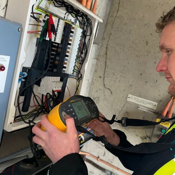 Nova Electrical engineer carrying out electrical testing on a commercial distribution board using test equipment