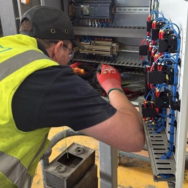 Nova Electrical engineer inspecting and testing a commercial electrical control panel